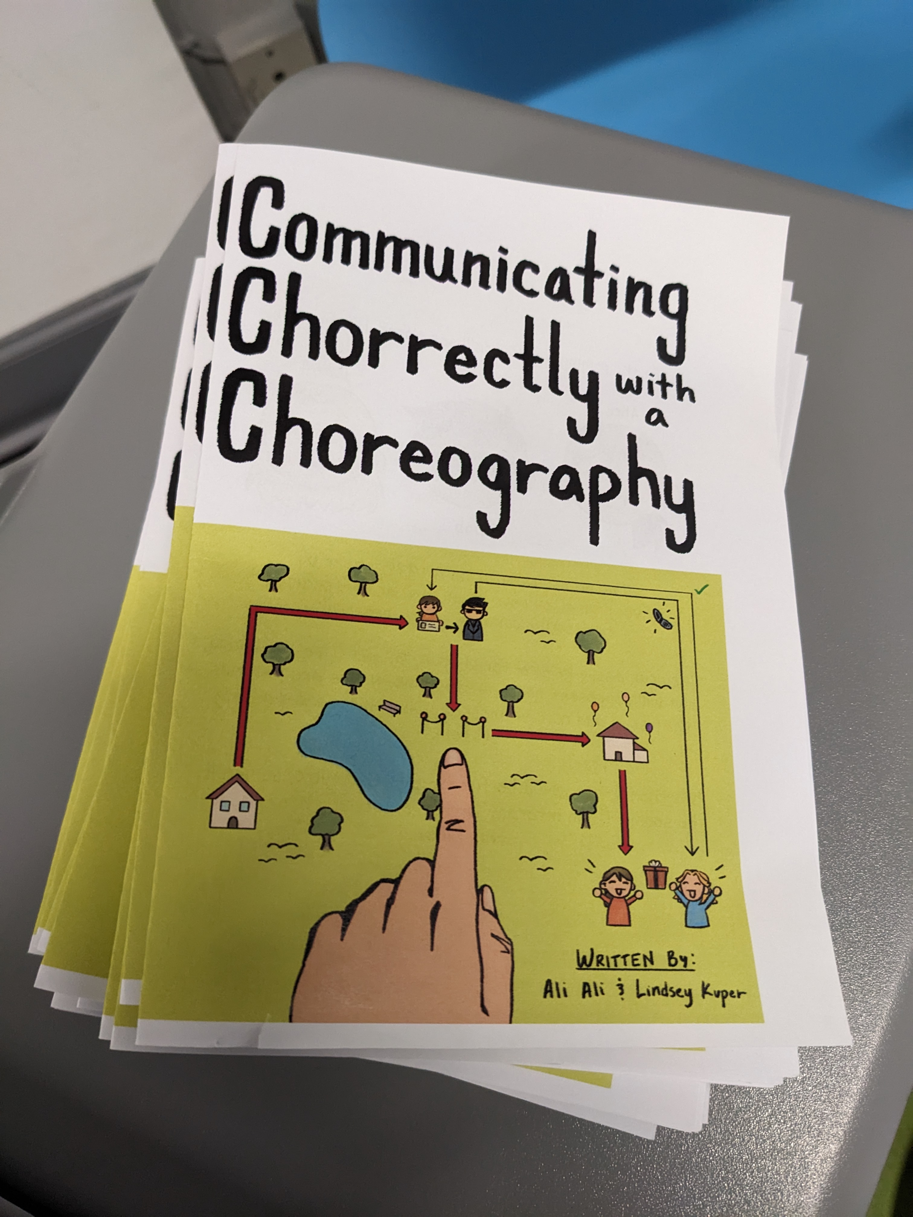 A stack of printed copies of 'Communicating Chorrectly with a Choreography' by Ali Ali and Lindsey Kuper